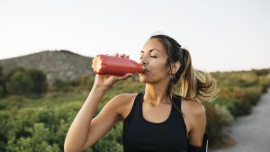 Woman drinking water after workout