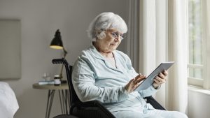 Senior woman using tablet PC at home