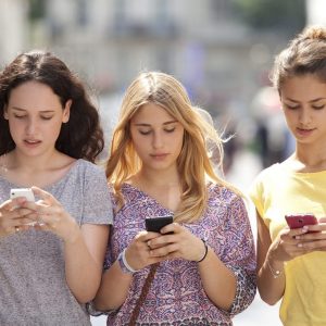 Three girls with their mobile phone