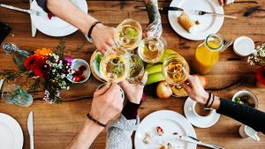 Young people having a toast with a glass of wine.