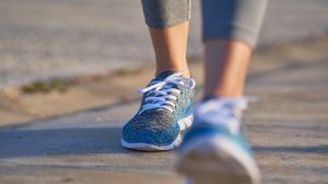 view of feet of sporty woman walking, copy space, unfocused view