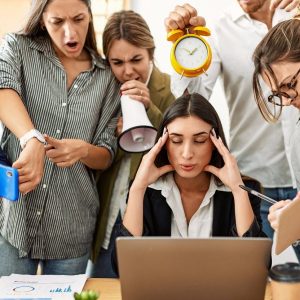 Group of business workers screaming to stressed partner at the office.