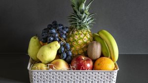 Basket of assorted fruits in the kitchen.