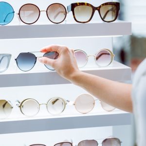 Returning fashionable sunglasses on the shelf